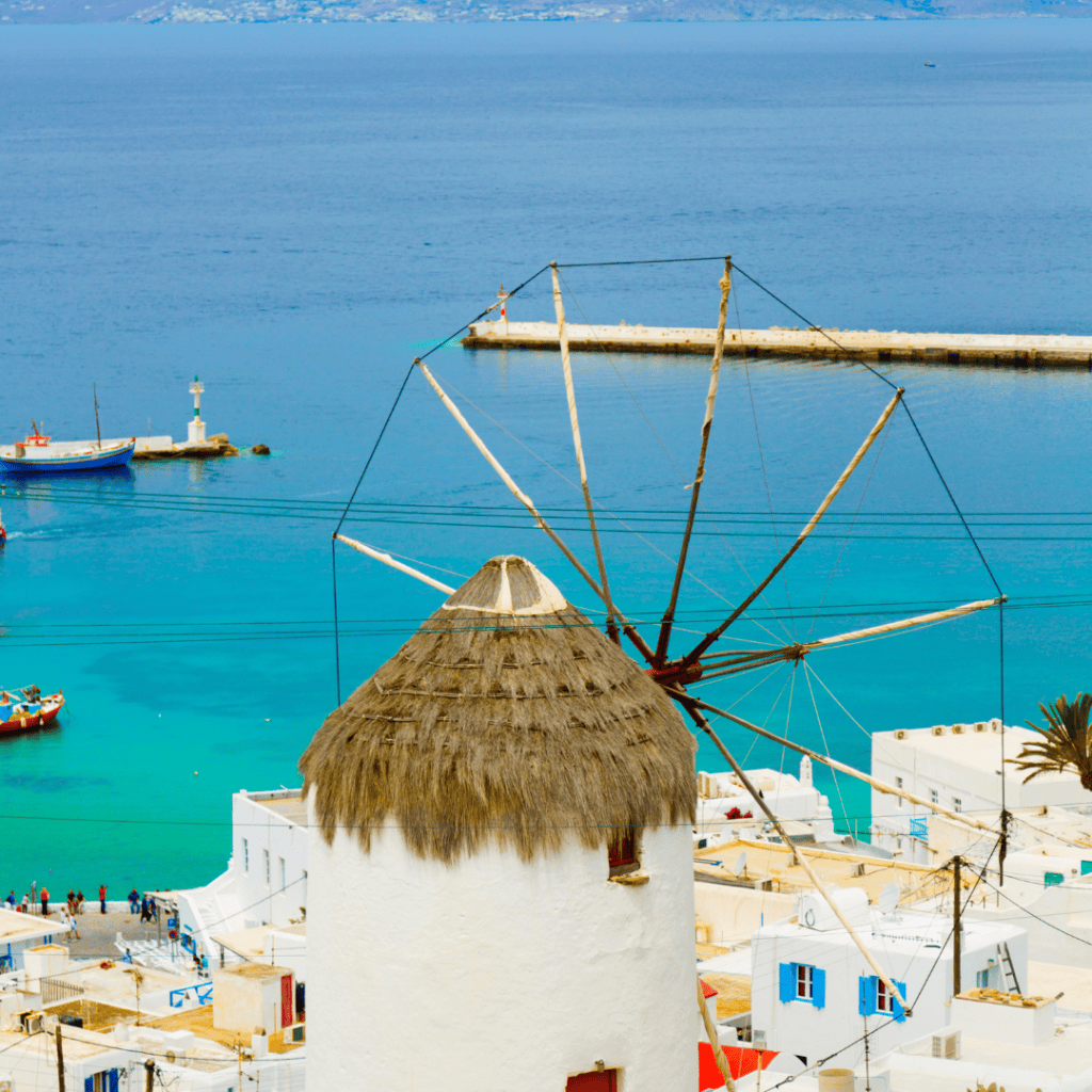 Mykonos windmills overlooking the sea at sunset Greece